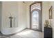 Light and airy entryway featuring tile floors, a console table, art niches, and an iron grid door at 4915 N Greentree Dr, Litchfield Park, AZ 85340