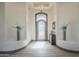 Beautiful foyer with tile floors, art niches, modern lighting, and an iron grid door at 4915 N Greentree Dr, Litchfield Park, AZ 85340