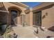 Charming front entryway showcases two doors and desert landscaping and exterior stone details at 4915 N Greentree Dr, Litchfield Park, AZ 85340