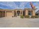 Beautiful desert home featuring an attached garage, desert landscaping, and a lovely front entrance at 4915 N Greentree Dr, Litchfield Park, AZ 85340