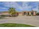 Stunning desert home showcasing an Arizona state flag, a circular driveway and desert landscaping at 4915 N Greentree Dr, Litchfield Park, AZ 85340