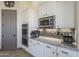 Kitchen area featuring white cabinetry, granite countertops, and stainless steel appliances at 4915 N Greentree Dr, Litchfield Park, AZ 85340