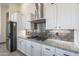 Bright kitchen showcases white cabinetry, subway tile backsplash and stainless appliances at 4915 N Greentree Dr, Litchfield Park, AZ 85340