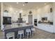 Spacious kitchen featuring an island, white cabinets, stainless steel appliances, and modern lighting at 4915 N Greentree Dr, Litchfield Park, AZ 85340