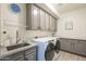 Functional laundry room with modern appliances, ample cabinetry, and granite countertops at 4915 N Greentree Dr, Litchfield Park, AZ 85340