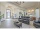 Open-concept living room showcases tile floors, modern lighting, a decorative ceiling, and views into the kitchen at 4915 N Greentree Dr, Litchfield Park, AZ 85340