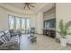 Bright living room featuring large windows, hardwood floors, and a large television at 4915 N Greentree Dr, Litchfield Park, AZ 85340