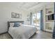 Bright main bedroom featuring a large window, tray ceiling and comfortable bedding at 4915 N Greentree Dr, Litchfield Park, AZ 85340