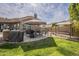 Well-equipped outdoor kitchen with a grill, dining area, and shade canopy at 4915 N Greentree Dr, Litchfield Park, AZ 85340