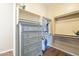 This walk-in closet is complete with custom shelving and a chest of drawers at 4915 N Greentree Dr, Litchfield Park, AZ 85340