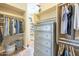 Spacious walk-in closet with ample storage, custom shelving, drawers, and hanging rods for organized clothing and accessories at 4915 N Greentree Dr, Litchfield Park, AZ 85340