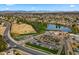 Aerial view showcasing nearby golf course and community amenities amidst a backdrop of residential homes at 4939 W Joyce Cir, Glendale, AZ 85308