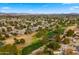 Expansive aerial view of a golf course community with lush green fairways and well-maintained homes at 4939 W Joyce Cir, Glendale, AZ 85308