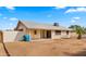 Backyard featuring a covered patio, sliding glass doors, block fence, and ample space for recreation at 4939 W Joyce Cir, Glendale, AZ 85308