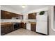 Traditional-style kitchen with ample cabinet space and white appliances in a well-lit setting at 4939 W Joyce Cir, Glendale, AZ 85308