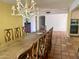 Dining room featuring rustic chandelier, tile floor, and large dining table at 537 N Jay St, Chandler, AZ 85225