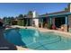 Backyard pool featuring a large inground pool, tile surround, and covered outdoor area at 537 N Jay St, Chandler, AZ 85225