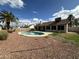 A refreshing pool accents the backyard's red rock landscaping and a well-maintained patio at 5552 W Willow Ave, Glendale, AZ 85304