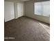 Bedroom with new carpet, closet, and window at 5552 W Willow Ave, Glendale, AZ 85304