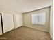 Bedroom featuring two closets, neutral walls, and window that provides ample natural light at 5552 W Willow Ave, Glendale, AZ 85304