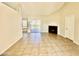 Open-concept living room with fireplace, tile flooring and sliding glass doors to the backyard at 5552 W Willow Ave, Glendale, AZ 85304