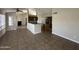 Open-concept living space with tile flooring, island counter, and fireplace at 5552 W Willow Ave, Glendale, AZ 85304