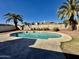 Backyard swimming pool framed by two palm trees and red gravel yard under a clear blue sky at 5552 W Willow Ave, Glendale, AZ 85304