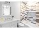 Well-lit bathroom with a gray and white mosaic tile wall, vanity and shower/tub combination at 5601 E Monterosa St, Phoenix, AZ 85018