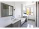 Bright bathroom featuring a soaking tub, double vanity, and herringbone tile flooring at 5601 E Monterosa St, Phoenix, AZ 85018