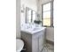 Bathroom vanity with chrome fixtures, white countertop, and gray cabinetry next to window at 5601 E Monterosa St, Phoenix, AZ 85018