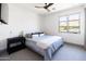 Bedroom featuring a ceiling fan, a comfortable bed with striped bedding, and a mountain view at 5601 E Monterosa St, Phoenix, AZ 85018