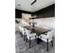 View of dining room with black accent wall, wainscoting, a contemporary chandelier and an open staircase at 5601 E Monterosa St, Phoenix, AZ 85018