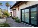 Exterior of a white modern farmhouse-style house features black trim and a stone walkway with landscaping at 5601 E Monterosa St, Phoenix, AZ 85018