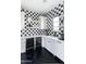 This kitchenette has black-and-white checkered tile, quartz countertops, a sink and a built-in dual-zone wine refrigerator at 5601 E Monterosa St, Phoenix, AZ 85018