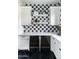 Close up of a kitchenette with black-and-white checkered tile and a built-in dual-zone wine refrigerator at 5601 E Monterosa St, Phoenix, AZ 85018