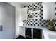 Side view of kitchenette with black-and-white checkered tile and a built-in dual-zone wine refrigerator at 5601 E Monterosa St, Phoenix, AZ 85018