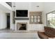 Living room with modern fireplace, mounted television, and nearby covered outdoor patio at 5601 E Monterosa St, Phoenix, AZ 85018