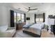 Inviting bedroom featuring a large window, wood dresser, ceiling fan and comfortable seating at 5601 E Monterosa St, Phoenix, AZ 85018