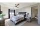 Serene main bedroom with a ceiling fan, ensuite bathroom and hardwood floors at 5601 E Monterosa St, Phoenix, AZ 85018