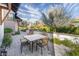 Outdoor dining patio features a gray brick floor, wall enclosure and an outdoor table with four chairs at 5601 E Monterosa St, Phoenix, AZ 85018