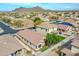 Aerial view of a neighborhood with mountains in the background and well-maintained landscaping at 6847 W Palo Brea Ln, Peoria, AZ 85383