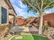 Backyard featuring concrete patio, built in firepit, landscape, and privacy walls at 6847 W Palo Brea Ln, Peoria, AZ 85383