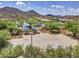 Full basketball court with shade structures near desert landscaping, perfect for enjoying outdoor activities in a beautiful setting at 6847 W Palo Brea Ln, Peoria, AZ 85383