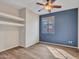 Bedroom with wood floors and built in shelving, and a large sunny window at 6847 W Palo Brea Ln, Peoria, AZ 85383