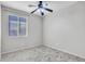 Neutral bedroom featuring tile floors, a ceiling fan, and a bright window at 6847 W Palo Brea Ln, Peoria, AZ 85383