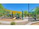 Community playground featuring slides, climbing structures, and shade canopies for outdoor fun at 6847 W Palo Brea Ln, Peoria, AZ 85383