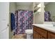 Neutral bathroom with a shower/tub combo, a wood vanity, and decorative elements at 7013 W Branham Ln, Laveen, AZ 85339