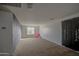 Bright bedroom with neutral carpet, featuring a teddy bear, and good natural light at 7013 W Branham Ln, Laveen, AZ 85339