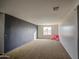 Spacious bedroom with neutral carpet, featuring a teddy bear, and good natural light at 7013 W Branham Ln, Laveen, AZ 85339