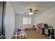 bedroom featuring a ceiling fan, window and toys at 7013 W Branham Ln, Laveen, AZ 85339